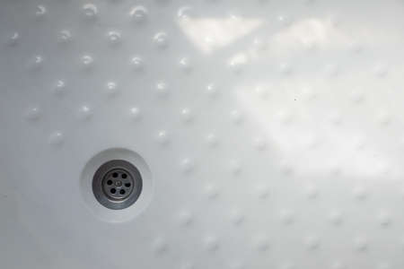 The drain in the white plastic shower. top viewの写真素材