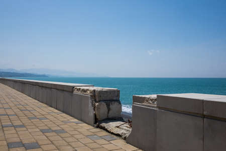 A rocky beach on the Black Sea in Kobuleti, Georgia. Ruined old parapetの写真素材