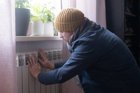 Man wearing warm clothing feeling cold . Energy crisis in Europeの写真素材