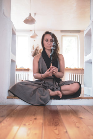 woman practicing yoga lesson, breathing, meditating, doing Padmasana exerciseの写真素材