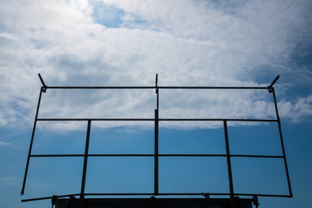 An old rusted steel billboard frame in a blue sky backgroundの写真素材