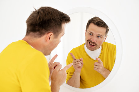 young man trying to cheer himself up before a first date