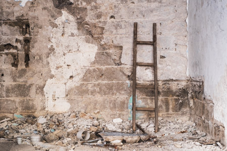 Stepladder and wallpaper against a gray rusty dirty concrete wallの写真素材