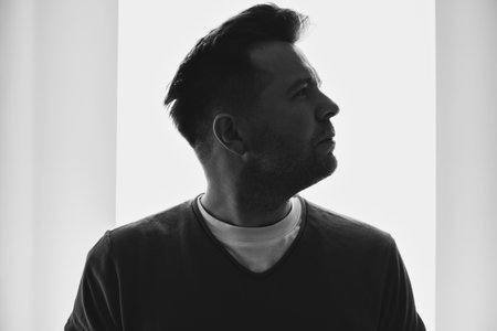 Silhouette portrait of young European man in profile isolated white background