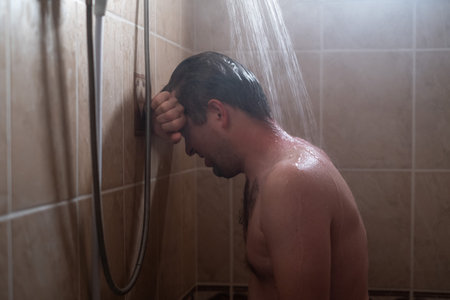 Sad Man Under Stress Taking a Shower