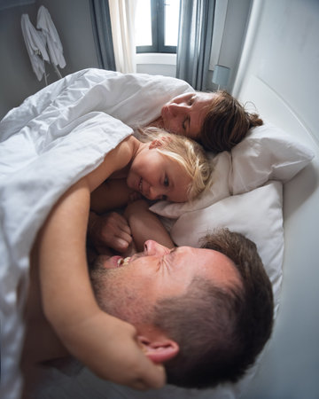 Little 4 year old girl waking up her parents in the morning