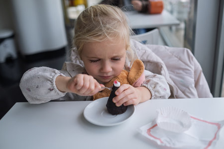 Girl eating chocolate cake in a cafeの写真素材