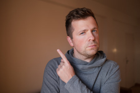 Middle Aged European Man Pointing Up with Index Fingerの写真素材