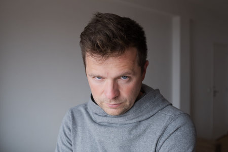 Mid Shot Emotional Portrait of a Middle Aged Man Looking Reproachfully at the Camera