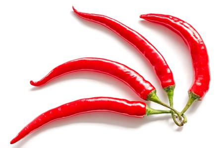 four red pepper on a white background, arranged like a fanの写真素材