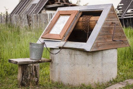 well in the Russian village with a bucket, exposed on the benchの写真素材