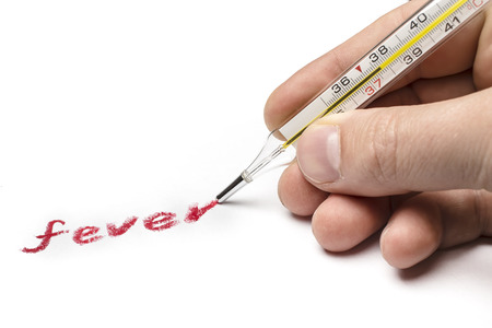 Doctor hand writing on paper symptom "fever", using instead of a pen medical thermometerの写真素材