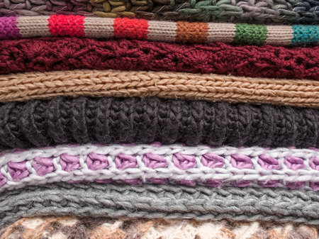 Stack of knitted woolen garments and knit different colors