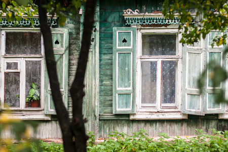 window with shutters and curtains in an old houseの写真素材