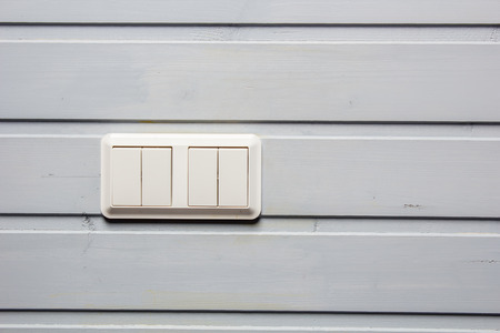 modern plastic buttons breaker electricity of white close-up on a gray wallの写真素材