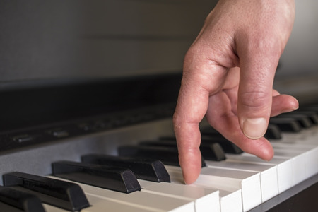 fingers click on the piano keys as if the legs