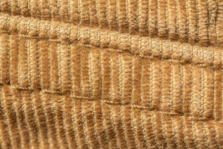 closeup seam on yellow material of corduroy pantsの写真素材