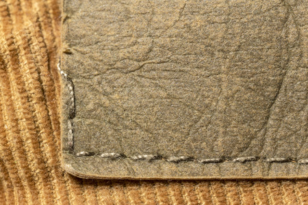 closeup of blank leather label on yellow material corduroy pantsの写真素材