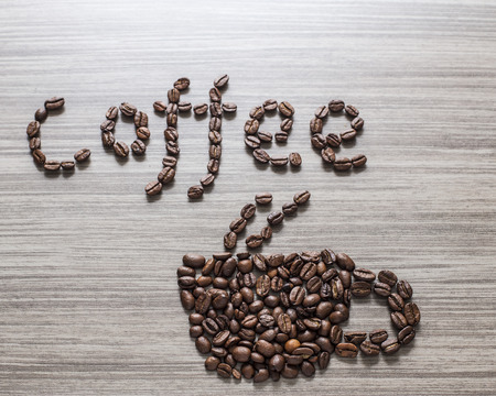 Word coffee a cup and written the grains, close-upの写真素材