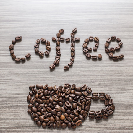 Word coffee a cup and written the grains, close-upの写真素材