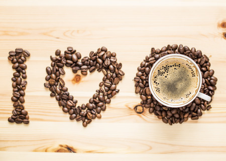 I love coffee hot, beans and a cup on the wooden tableの写真素材