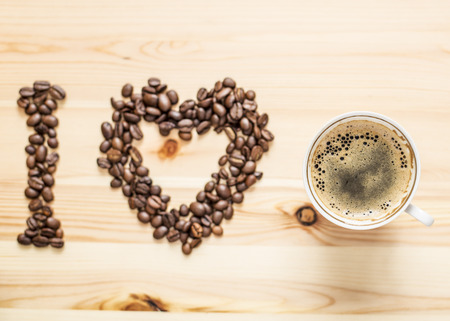 I love coffee hot, beans and a cup on the wooden tableの写真素材