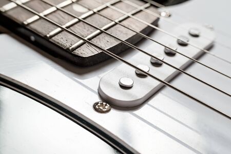 Body and neck with strings of a modern, electronic guitar, close-up.の写真素材