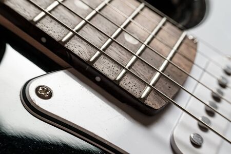 Body and neck with strings of a modern, electronic guitar, close-up.の写真素材