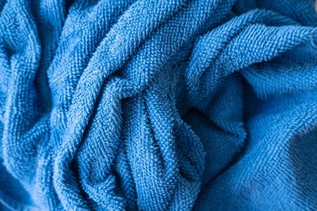 Crumpled terry, blue towel, top view. Background.の写真素材