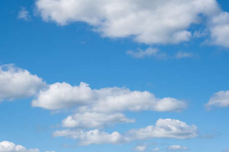 Blue sky and fluffy, white clouds on a summer day.の写真素材