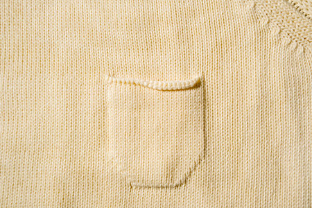 Knitted background with pocket, yellow, with copy space. Top view.の写真素材