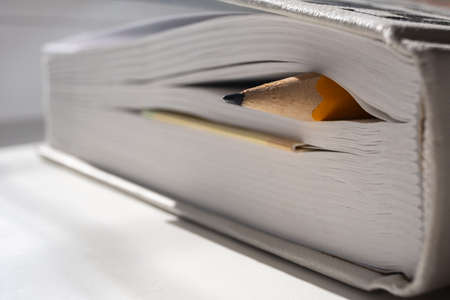 Sharpened pencil is in the pages of a closed book. Education concept.の写真素材