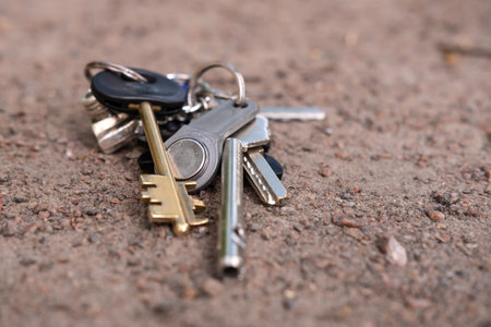 Keys and keychain, lost, lie on the road. Bottom view.の写真素材