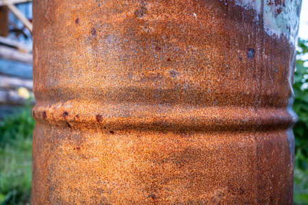 Rusty, old barrel stands outdoors in the countryside. Close-up.の写真素材