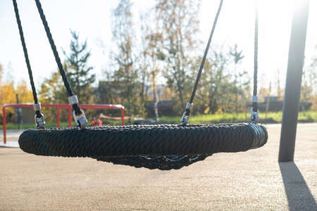 Wicker swings hang on a specially equipped playground, outdoors, in a park, on an autumn day.の写真素材