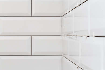 New white tiles in the bathroom. Wall decoration process. Home repairs.の写真素材