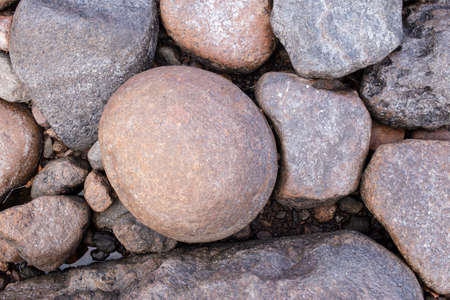 Stones of various sizes on the seashore. Background. Top view.の写真素材