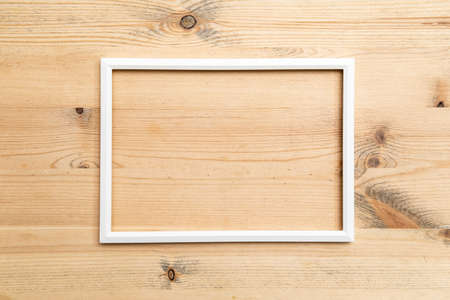 Rectangular blank white frame on wood texture. Abstract background. Copy space. Top view.の写真素材