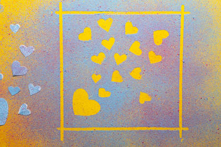 Valentines Day. Hearts symbol of love in a frame and next to it, made of multicolored bright powder,...