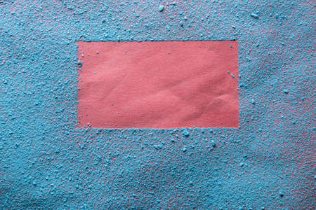 Imprint of a bright red frame on blue powder. Copy space. Abstract background. Top view.の写真素材