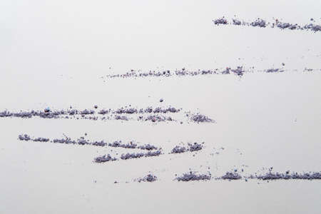 Bright powder scattered in the form of lines on a white background. Copy space. Dry paint in a...