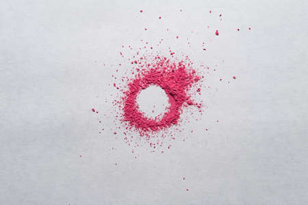 Circle made of red powder on a white background. Copy space. Dry paint with bright color. Top view.の写真素材