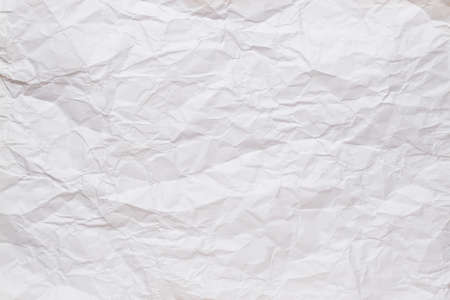 Crumpled, straightened sheet of white paper. Textured background. Copy space. Top view.の写真素材