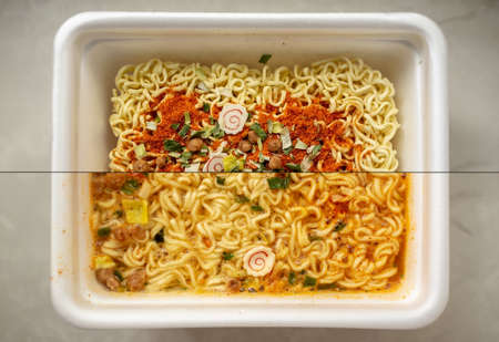 Instant noodles with spices, with broth and dry, in a disposable bowl, on the table. Unhealthy but...