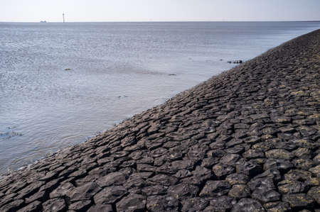 Cobblestone embankment. The seashore, fortified with stones from washout by water.