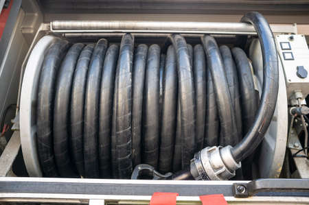 Hose needed to put out the fire is rolled up in the fire engine.