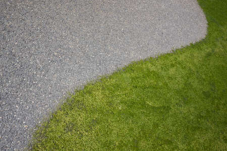 Curved lines of green lawn and asphalt, for the background. Copy space. Top view.の写真素材