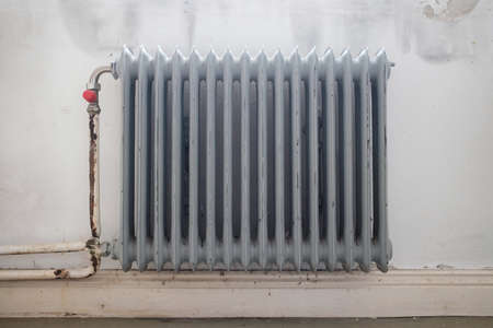 Old radiator, gray, in the room. Close-up.の写真素材