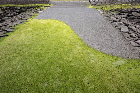 Path for walking from asphalt, lawn and cobblestones.