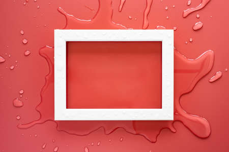 White rectangular empty frame on clean spilled water, on a pink background. Copy space. Top view.